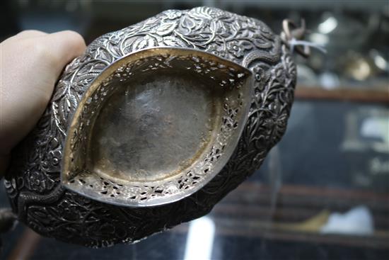 An Indian? white metal oval bowl with ring handles and three other items including two filligree items.